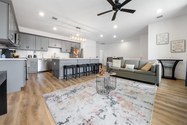 5214 Sherman St, Houston, TX 77011 - living room featuring ceiling fan, light wood finished floors, and recessed lighting