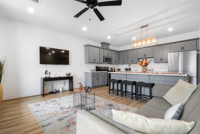 5214 Sherman St, Houston, TX 77011 - living room featuring ceiling fan, light wood finished floors, and recessed lighting
