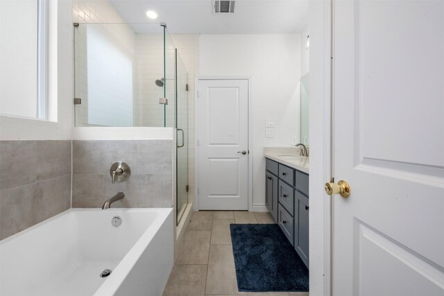 5214 Sherman St, Houston, TX 77011 - full bathroom featuring vanity, a bath, a shower stall, and tile patterned floors