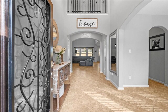 2424 Santiago Ln, League City, TX 77573 - foyer entrance featuring arched walkways and light tile patterned floors