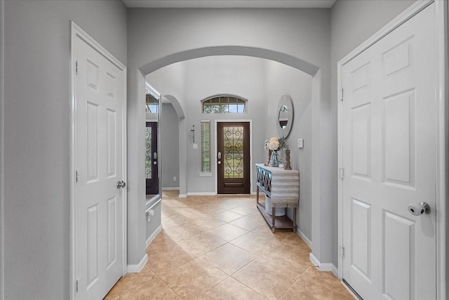 2424 Santiago Ln, League City, TX 77573 - foyer entrance featuring arched walkways and light tile patterned floors