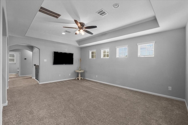 2424 Santiago Ln, League City, TX 77573 - empty room with a raised ceiling, arched walkways, a ceiling fan, carpet, and recessed lighting