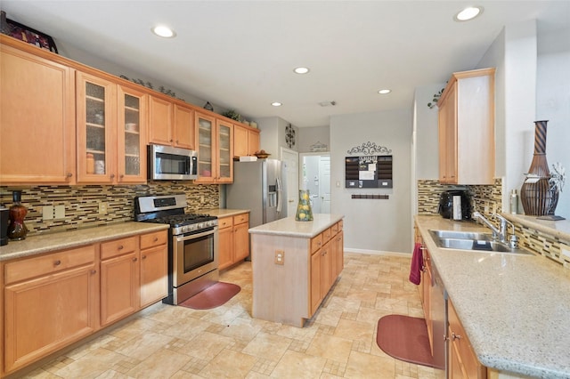 6027 Stone Trail Ln, Spring, TX 77379 - kitchen featuring appliances with stainless steel finishes, a kitchen island, tasteful backsplash, recessed lighting, and light stone finish floors