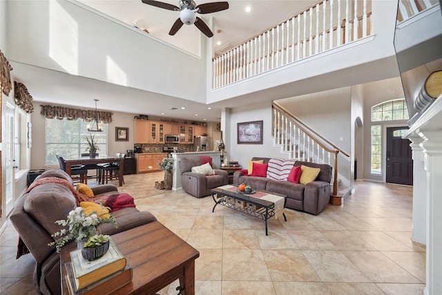 6027 Stone Trail Ln, Spring, TX 77379 - living room featuring a towering ceiling, stairway, a ceiling fan, light tile patterned flooring, and recessed lighting