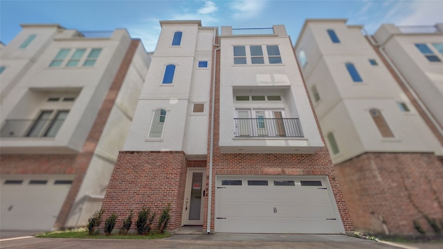 1844 Colquitt St, Houston, TX 77098 - view of property with a garage and concrete driveway