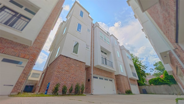 1844 Colquitt St, Houston, TX 77098 - view of building exterior featuring a garage and concrete driveway