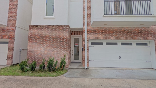 1844 Colquitt St, Houston, TX 77098 - doorway to property featuring stucco siding, a garage, driveway, and brick siding
