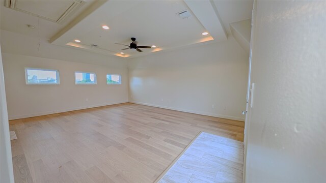 1844 Colquitt St, Houston, TX 77098 - spare room with a tray ceiling, attic access, ceiling fan, recessed lighting, and light wood-type flooring