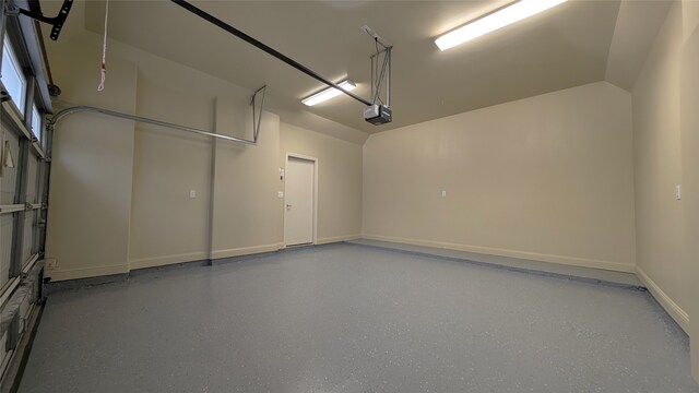 1844 Colquitt St, Houston, TX 77098 - garage featuring a garage door opener and baseboards