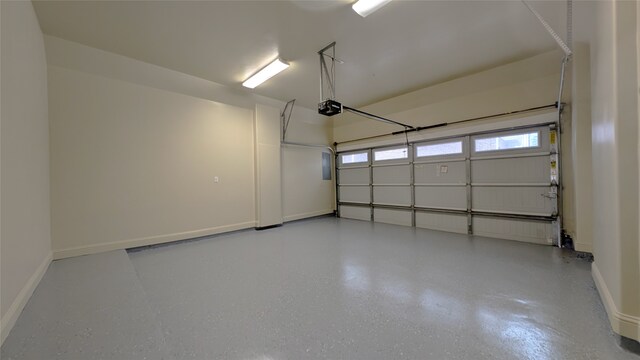 1844 Colquitt St, Houston, TX 77098 - garage featuring a garage door opener and baseboards