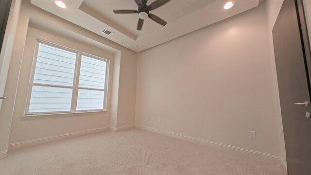 1844 Colquitt St, Houston, TX 77098 - spare room with a ceiling fan, light carpet, a tray ceiling, and recessed lighting