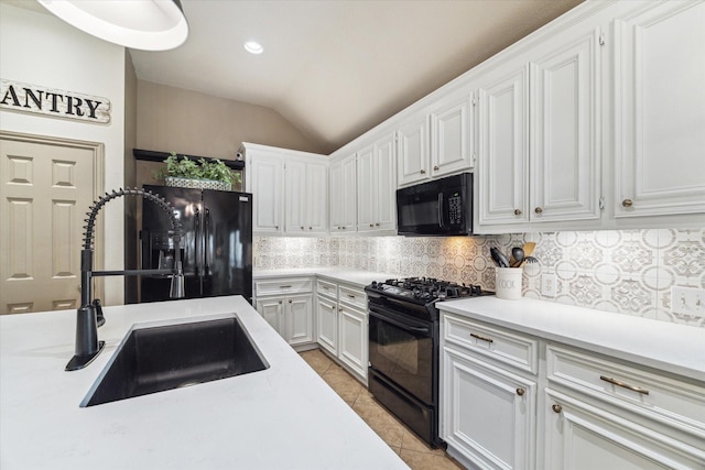 2826 Lakecrest Forest Dr, Katy, TX 77493 - kitchen with black appliances, backsplash, light countertops, white cabinetry, and lofted ceiling