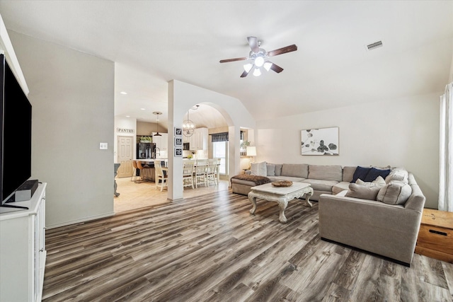 2826 Lakecrest Forest Dr, Katy, TX 77493 - living area featuring arched walkways, wood finished floors, ceiling fan, and lofted ceiling