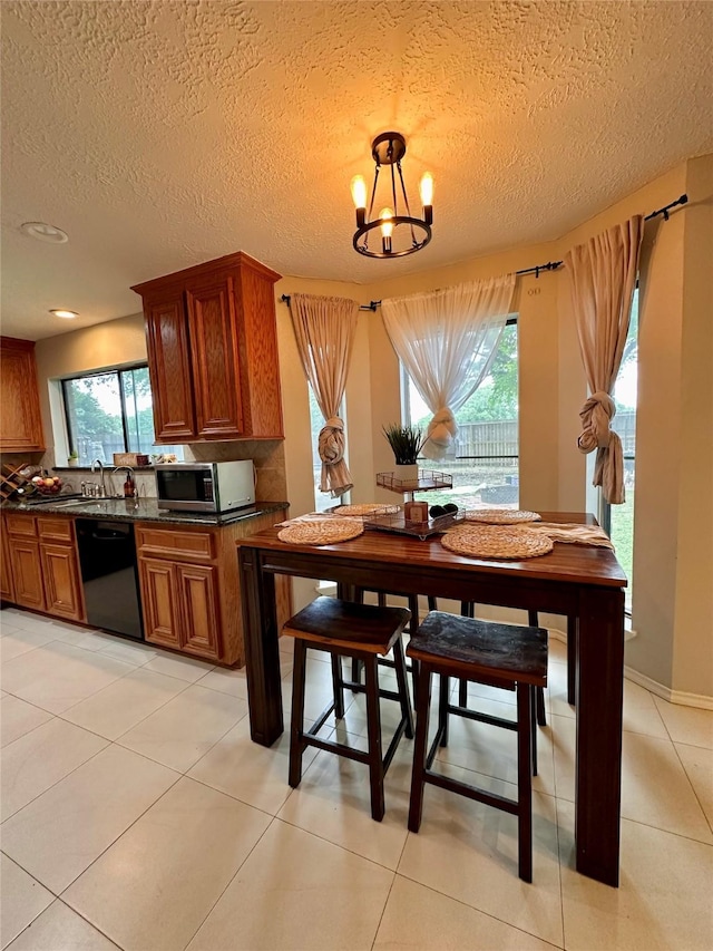 5103 Kleinbrook Dr, Houston, TX 77066 - dining room featuring a textured ceiling, light tile patterned floors, and a chandelier