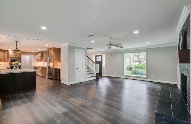 7922 Kleingreen Ln, Spring, TX 77379 - living area featuring a fireplace, stairs, crown molding, a ceiling fan, and recessed lighting