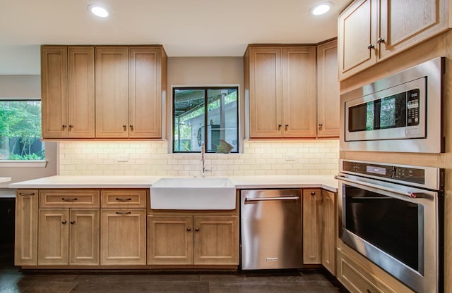 7922 Kleingreen Ln, Spring, TX 77379 - kitchen featuring appliances with stainless steel finishes, light countertops, tasteful backsplash, recessed lighting, and brown cabinetry