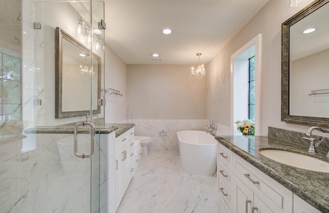 7922 Kleingreen Ln, Spring, TX 77379 - full bathroom featuring two vanities, a marble finish shower, a chandelier, a freestanding bath, and recessed lighting