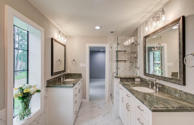 7922 Kleingreen Ln, Spring, TX 77379 - bathroom featuring marble look tile flooring, plenty of natural light, a marble finish shower, two vanities, and recessed lighting