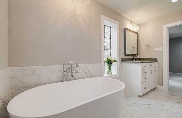 7922 Kleingreen Ln, Spring, TX 77379 - full bathroom featuring vanity, a freestanding tub, and marble finish floors