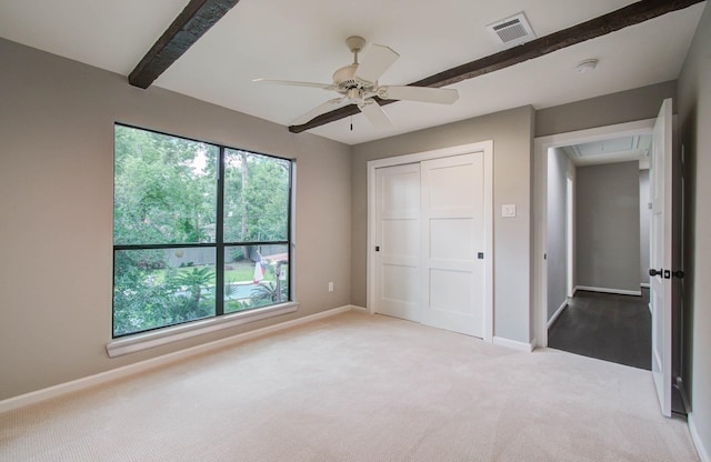 7922 Kleingreen Ln, Spring, TX 77379 - unfurnished bedroom featuring attic access, carpet flooring, a closet, beamed ceiling, and a ceiling fan