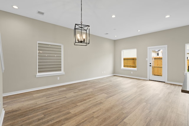 416 Stonework Landing Ln, Houston, TX 77076 - unfurnished room with a chandelier, light wood-type flooring, and recessed lighting