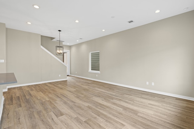 416 Stonework Landing Ln, Houston, TX 77076 - unfurnished living room featuring a chandelier, light wood-type flooring, and recessed lighting