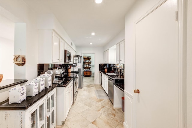 13050 Trail Hollow Dr, Houston, TX 77079 - kitchen with stainless steel appliances, dark countertops, recessed lighting, white cabinets, and light tile patterned floors
