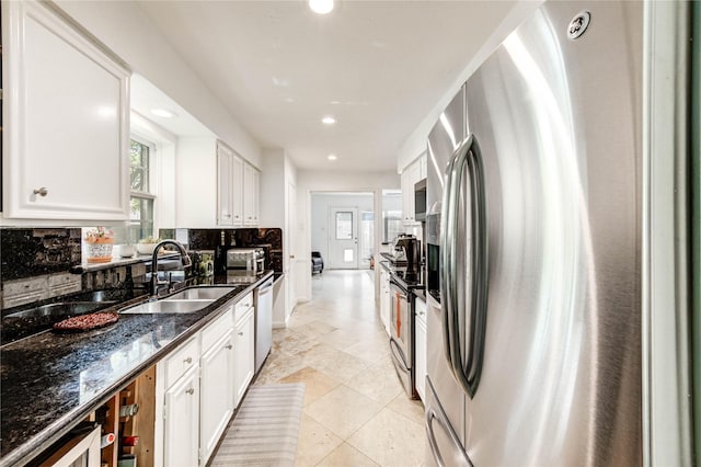13050 Trail Hollow Dr, Houston, TX 77079 - kitchen featuring stainless steel appliances, decorative backsplash, white cabinetry, recessed lighting, and dark stone countertops