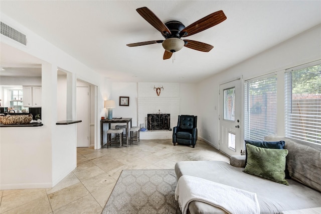 13050 Trail Hollow Dr, Houston, TX 77079 - living area featuring a brick fireplace, a ceiling fan, and light tile patterned floors