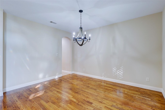 5507 Opal Cove Ct, Katy, TX 77494 - empty room featuring a chandelier, arched walkways, and light wood-style flooring