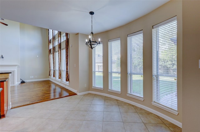 5507 Opal Cove Ct, Katy, TX 77494 - unfurnished dining area featuring a chandelier, a fireplace, and light tile patterned flooring