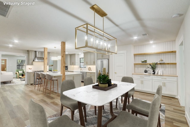 707 N Main St, Dayton, TX 77535 - dining space featuring light wood finished floors, a chandelier, recessed lighting, and healthy amount of natural light