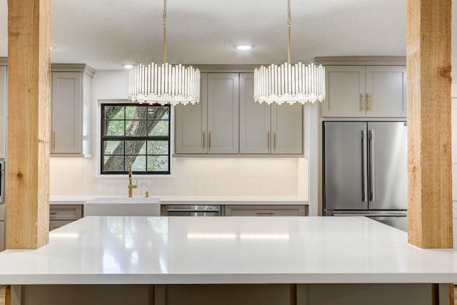 707 N Main St, Dayton, TX 77535 - kitchen with stainless steel appliances, gray cabinetry, a sink, light countertops, and recessed lighting