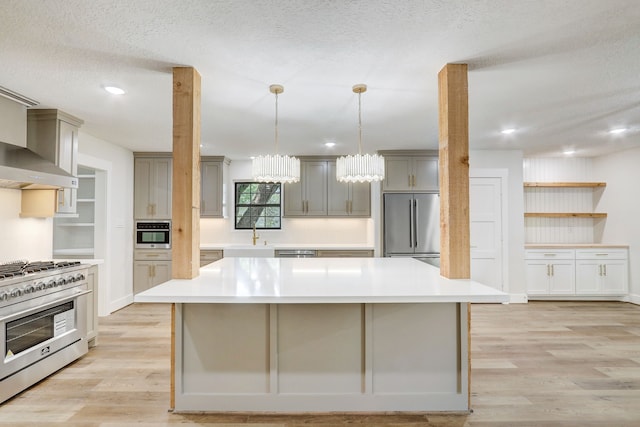707 N Main St, Dayton, TX 77535 - kitchen featuring stainless steel appliances, gray cabinetry, light wood-type flooring, light countertops, and recessed lighting