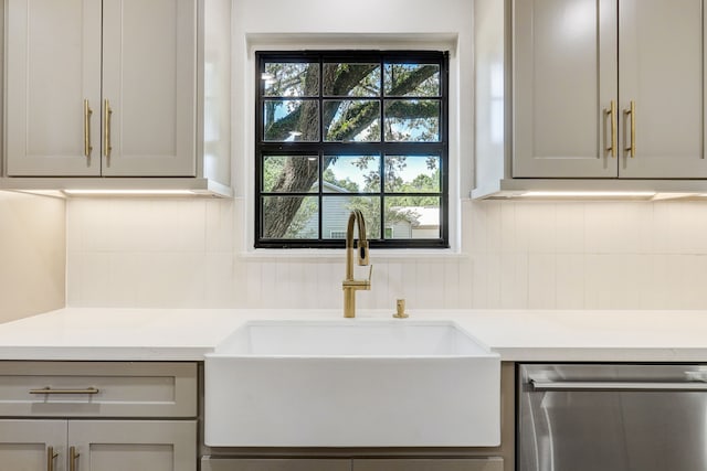 707 N Main St, Dayton, TX 77535 - kitchen featuring a sink, stainless steel dishwasher, healthy amount of natural light, and light countertops