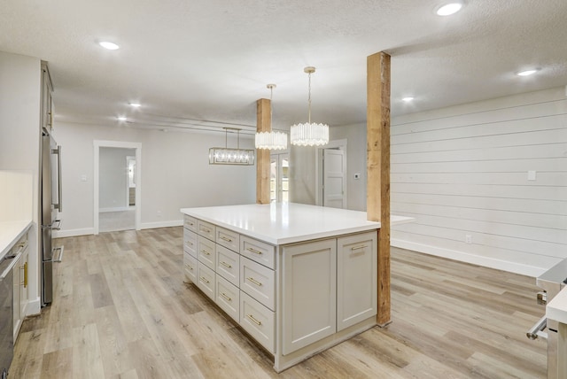 707 N Main St, Dayton, TX 77535 - kitchen with freestanding refrigerator, light wood finished floors, light countertops, a center island, and baseboards