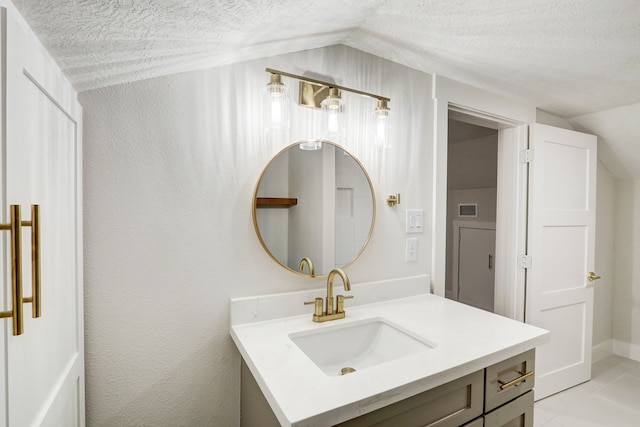 707 N Main St, Dayton, TX 77535 - bathroom featuring vaulted ceiling, a textured ceiling, vanity, and a textured wall