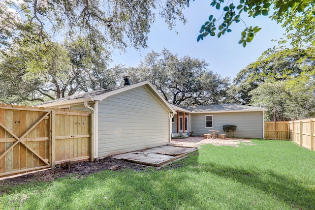 707 N Main St, Dayton, TX 77535 - back of house with a fenced backyard, a gate, and a patio