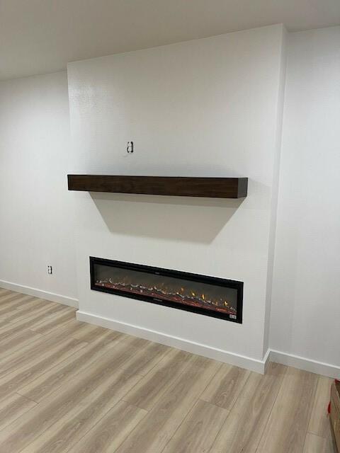 1221 N Hamilton St, Gonzales, TX 78629 - detailed view of a glass covered fireplace and wood finished floors