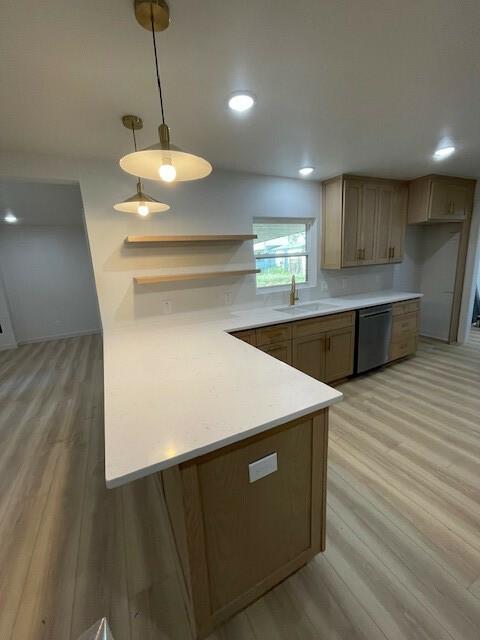 1221 N Hamilton St, Gonzales, TX 78629 - kitchen with stainless steel dishwasher, light wood-style flooring, a peninsula, light countertops, and recessed lighting
