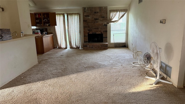 1830 Lansdowne Dr, Richmond, TX 77406 - unfurnished living room with carpet and a brick fireplace