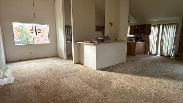 1830 Lansdowne Dr, Richmond, TX 77406 - kitchen featuring light colored carpet, plenty of natural light, a chandelier, and a towering ceiling
