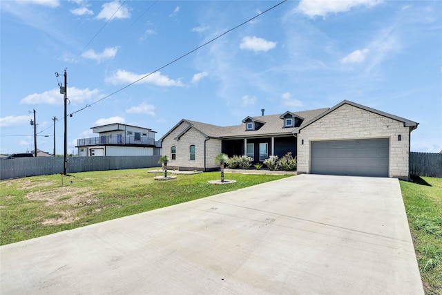 108 Bianca Cir, Del Valle, TX 78617 - view of front of home featuring driveway, a garage, and stone siding