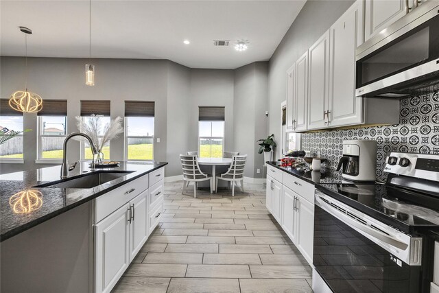 108 Bianca Cir, Del Valle, TX 78617 - kitchen featuring stainless steel appliances, tasteful backsplash, white cabinetry, and recessed lighting