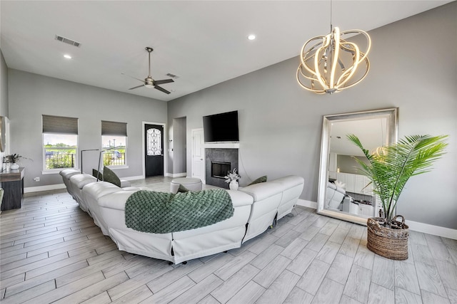 108 Bianca Cir, Del Valle, TX 78617 - living area featuring a ceiling fan, a tile fireplace, light wood-type flooring, a chandelier, and recessed lighting