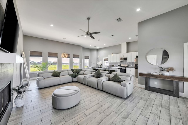 108 Bianca Cir, Del Valle, TX 78617 - living area with a ceiling fan, recessed lighting, a fireplace, and light wood finished floors