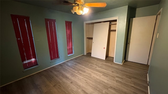 12414 Frazier River Dr, Houston, TX 77050 - unfurnished bedroom featuring wood finished floors, a ceiling fan, and multiple closets