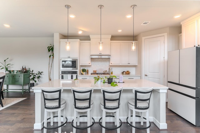 1206 Raburn Run Ln, Tomball, TX 77375 - kitchen featuring freestanding refrigerator, stainless steel oven, built in microwave, backsplash, and light countertops