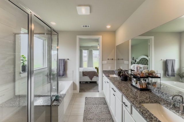 1206 Raburn Run Ln, Tomball, TX 77375 - ensuite bathroom with double vanity, a garden tub, tile patterned floors, a shower stall, and recessed lighting