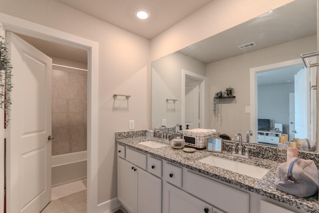 1206 Raburn Run Ln, Tomball, TX 77375 - full bath featuring double vanity, connected bathroom, tile patterned floors, and shower / tub combination
